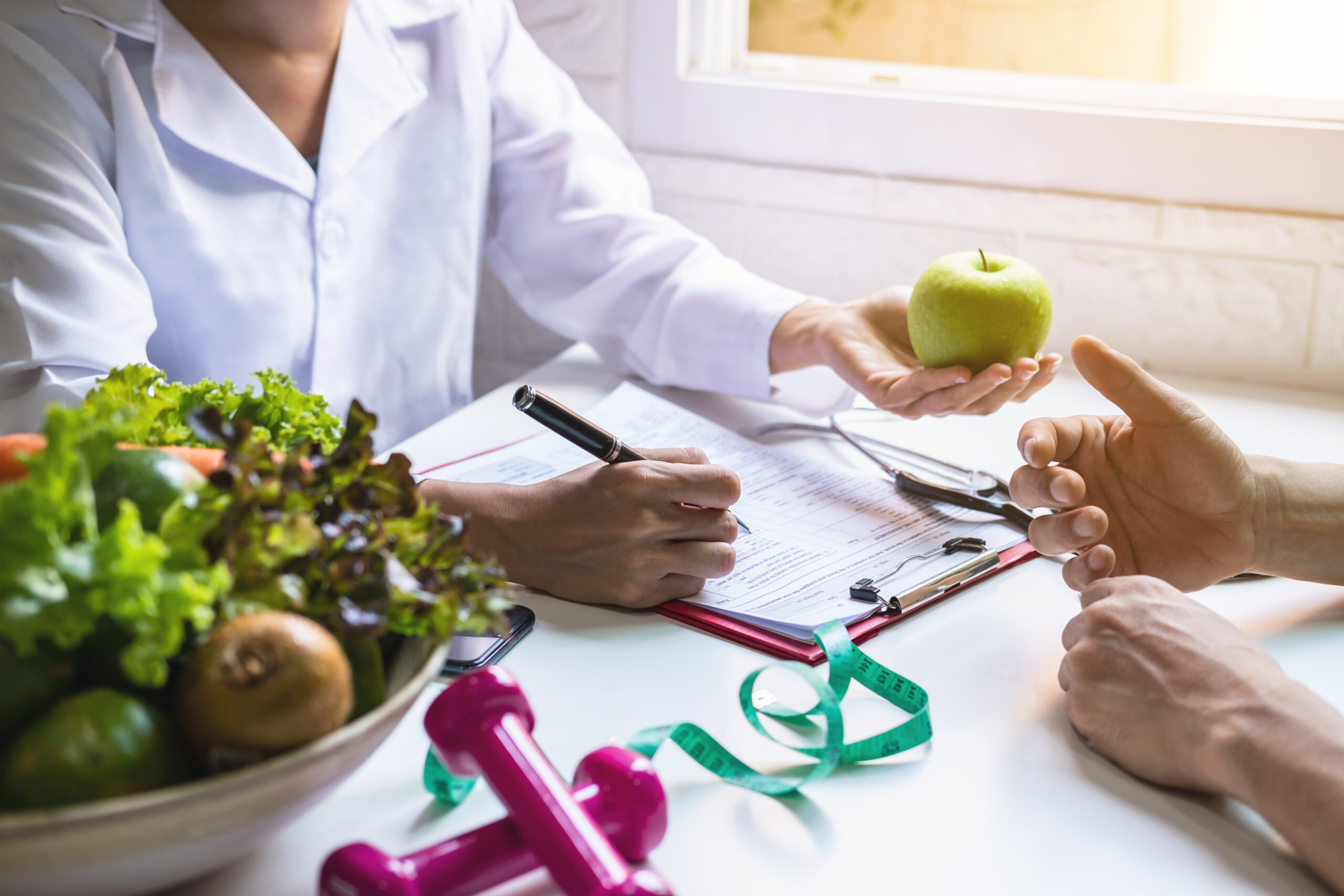 nutritionist teaching patient how to heal a wound with healthy food choices