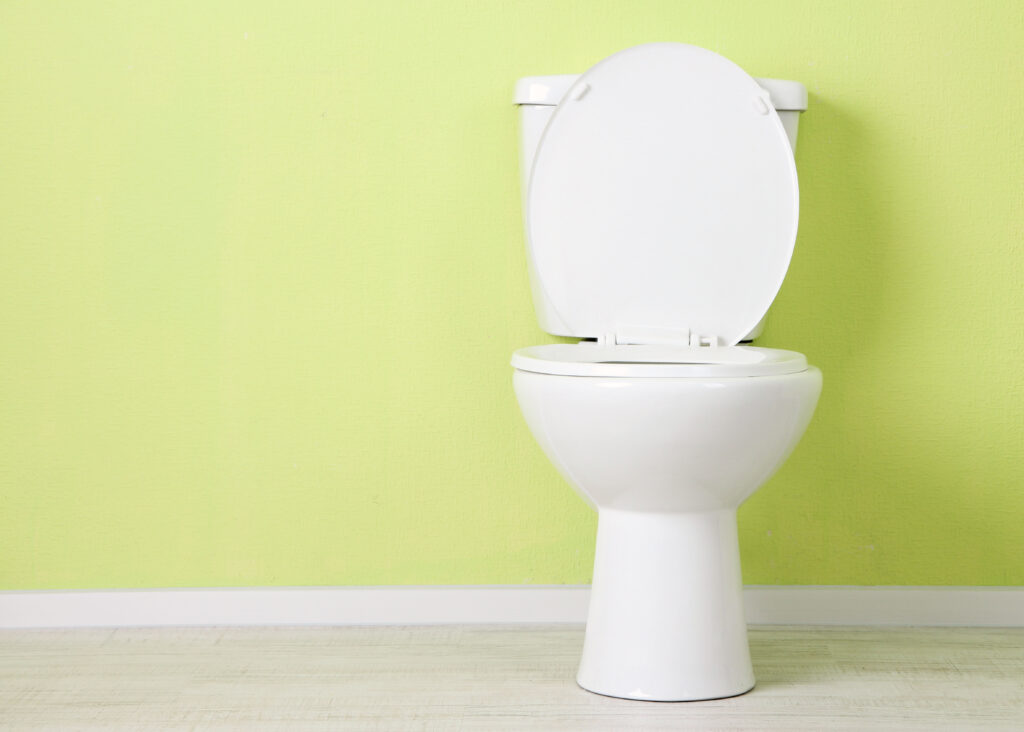 White toilet with green background