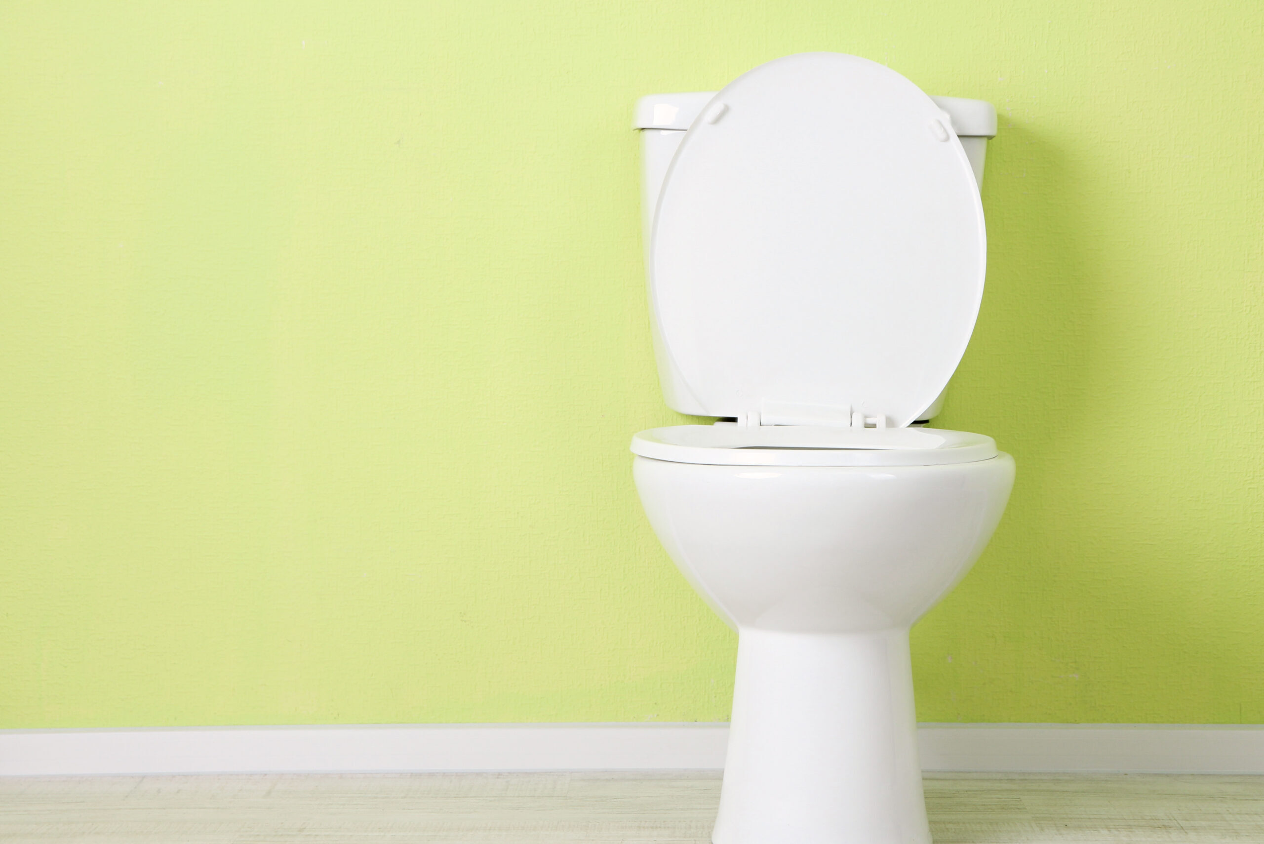 White toilet with green background