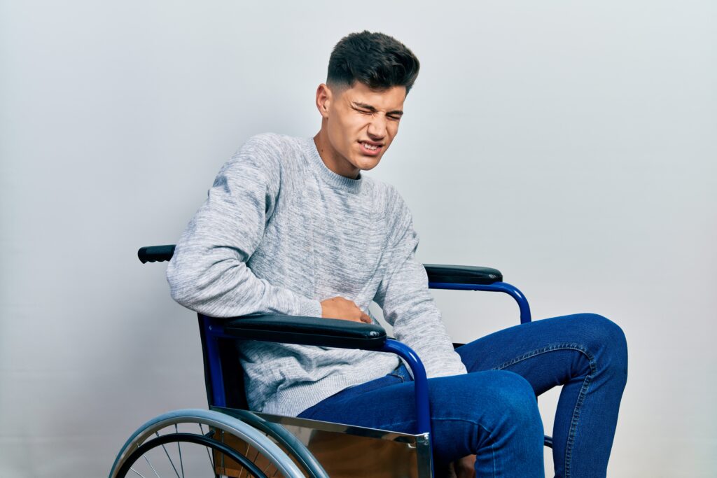 Boy in wheelchair in pain from kidney stone
